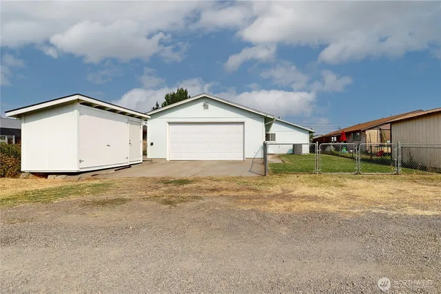 a view of garage and wooden fence