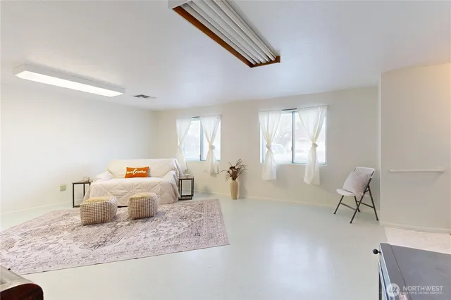 a bedroom with furniture and a window