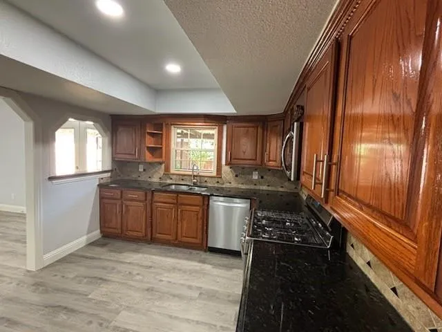 a kitchen with a refrigerator and a stove