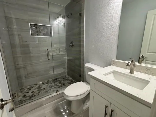 a bathroom with a sink toilet and shower