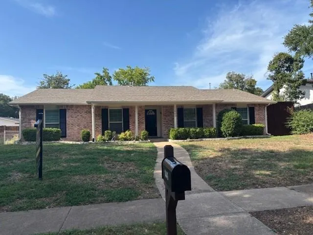 a front view of a house with a yard and porch