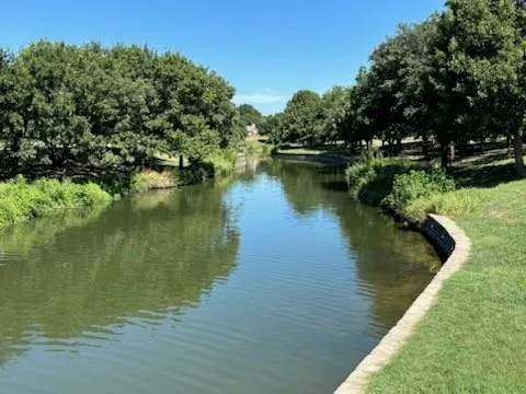a view of a lake with a house in the background