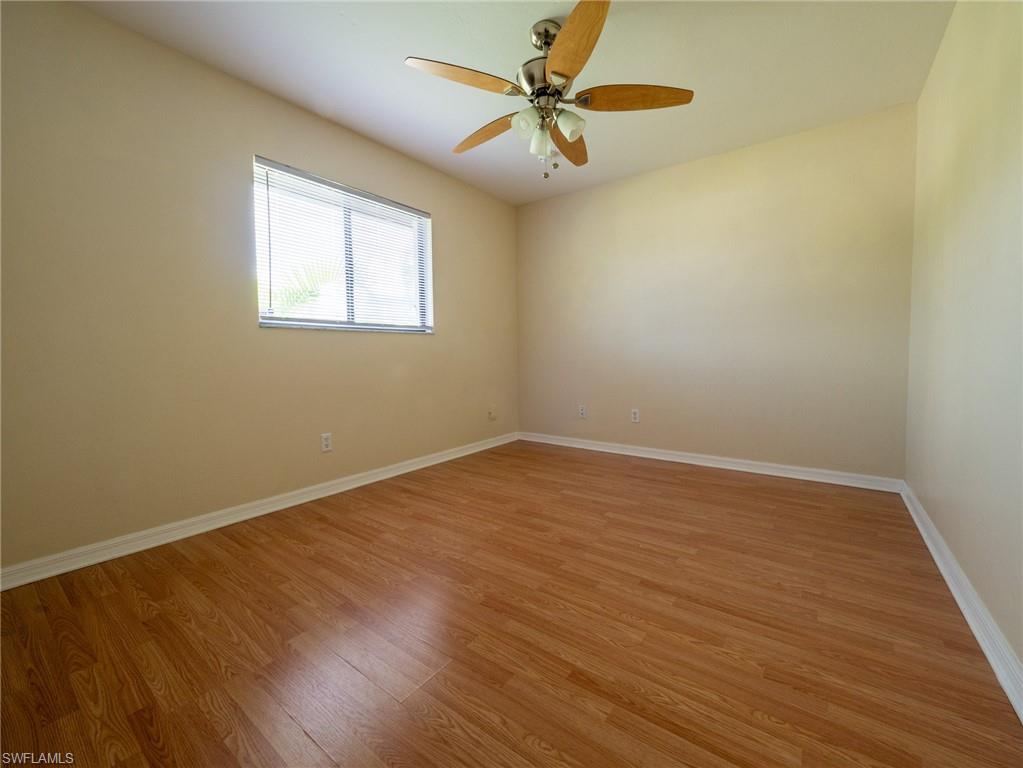 18414 Tulip Road Fort Myers, FL 33967 - Photo 27 of 37 Room featuring wood-finish flooring, a window with horizontal blinds, and a ceiling fan with integrated lighting