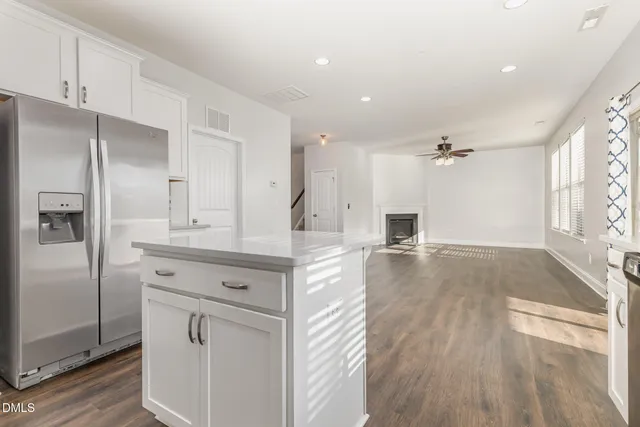 a kitchen with stainless steel appliances granite countertop a stove a sink and white cabinets