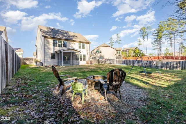 a view of a house with backyard and porch