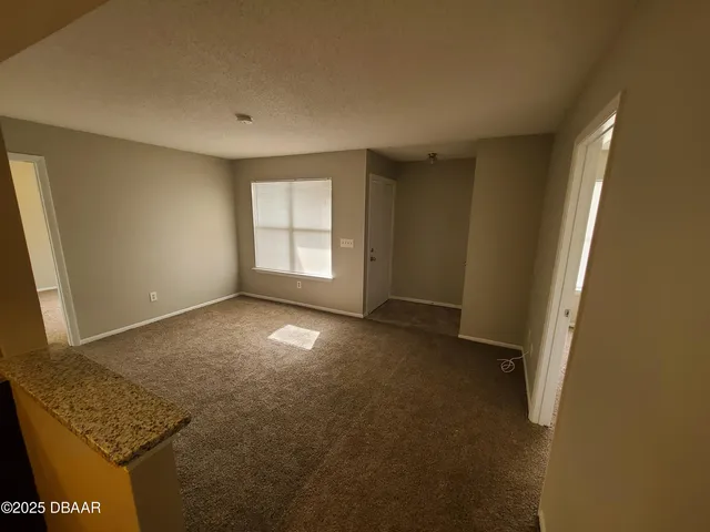 a kitchen with a refrigerator and a stove