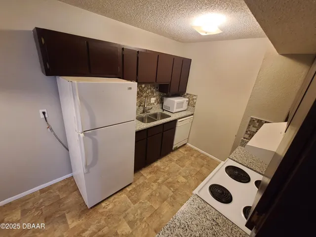 a kitchen with a sink and a refrigerator
