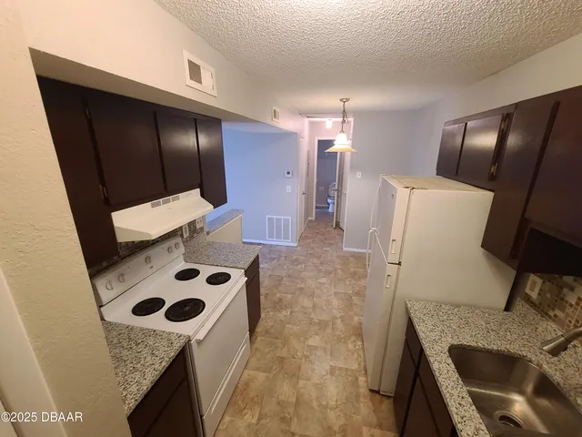 a kitchen with a stove and a refrigerator