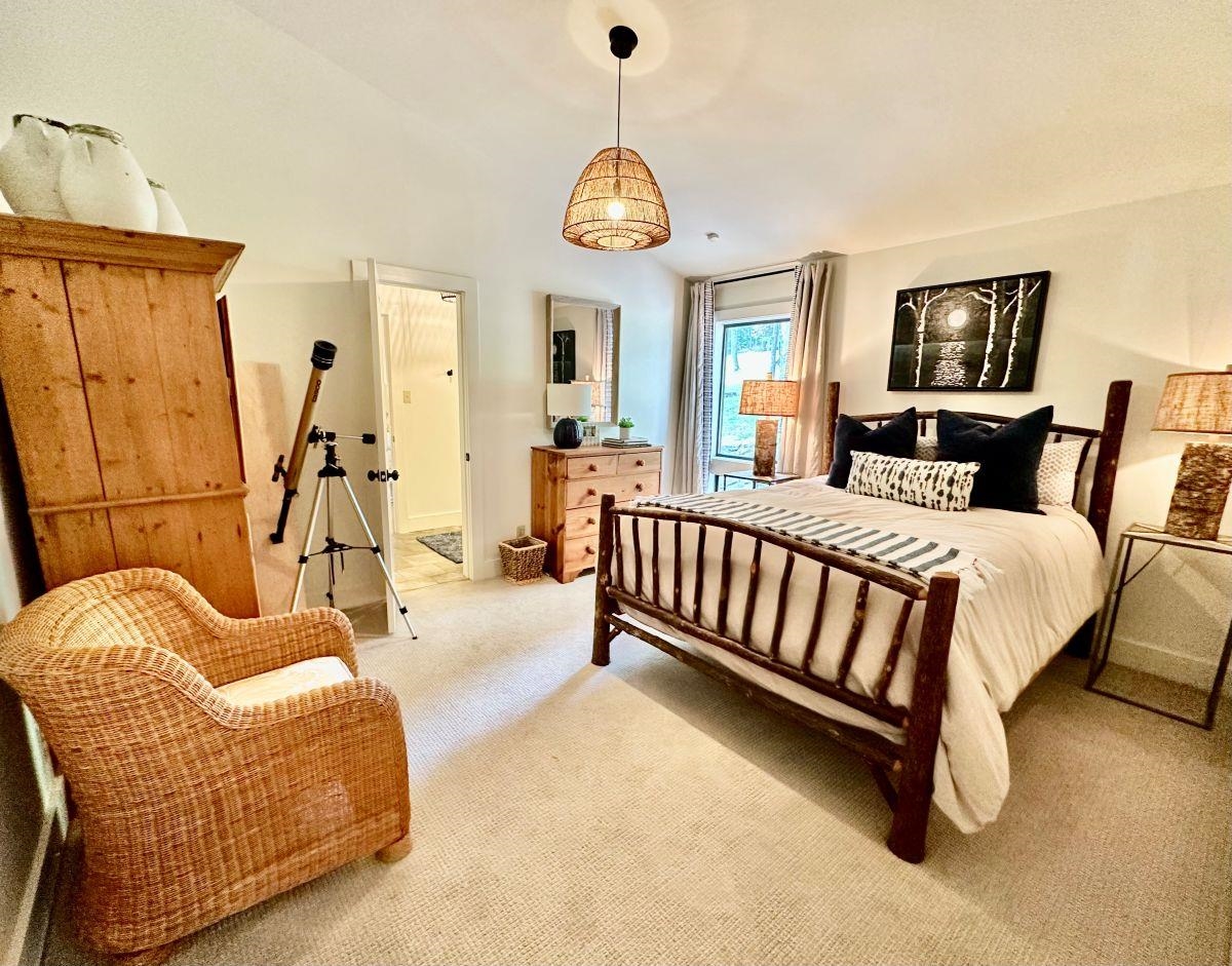 150 Turley Lane Counce, TN 38326 - Photo 16 of 37 a spacious bedroom with a bed and a chandelier