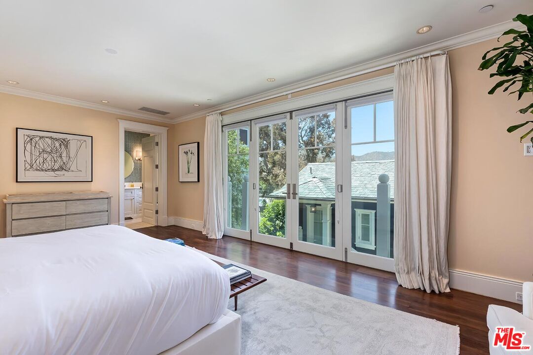 119 Malibu Colony Road Malibu, CA 90265 - Photo 14 of 24 a bedroom with a large bed and a large window