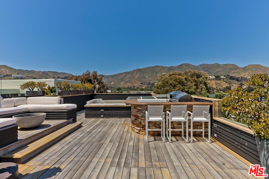 119 Malibu Colony Road Malibu, CA 90265 - Photo 22 of 24 a view of a terrace with couches and wooden floor