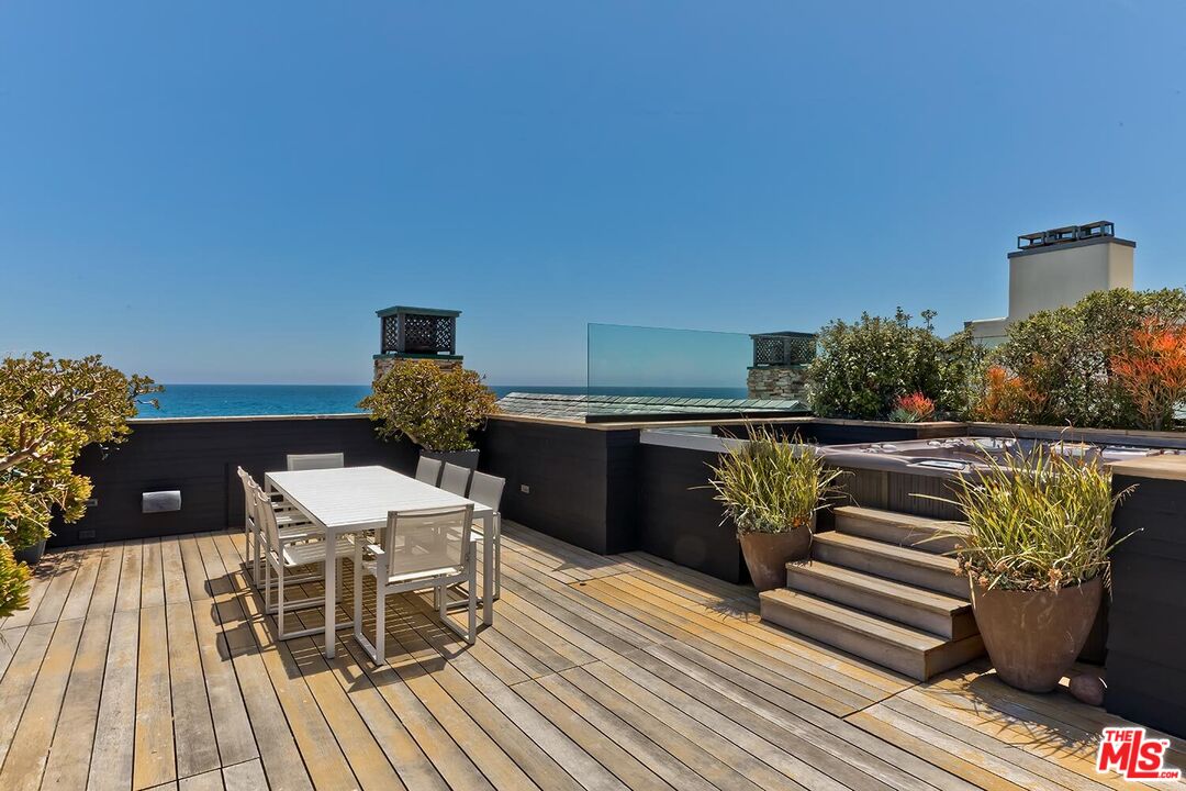 119 Malibu Colony Road Malibu, CA 90265 - Photo 23 of 24 a balcony with a table and chairs