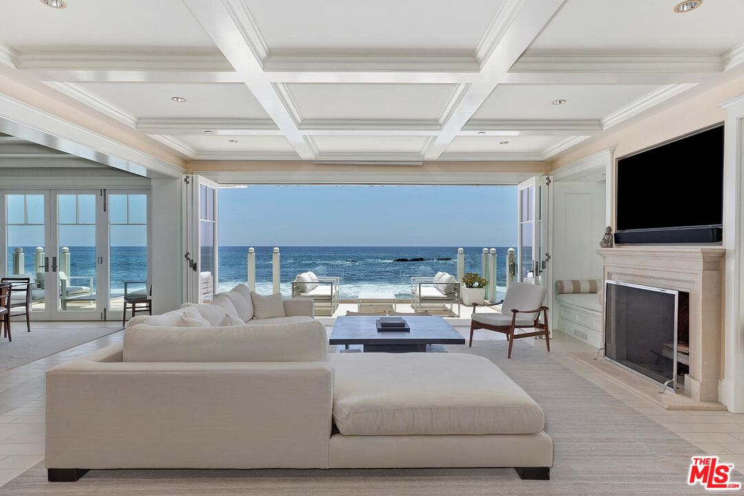 119 Malibu Colony Road Malibu, CA 90265 - Photo 5 of 24 a living room with furniture a fireplace and a flat screen tv