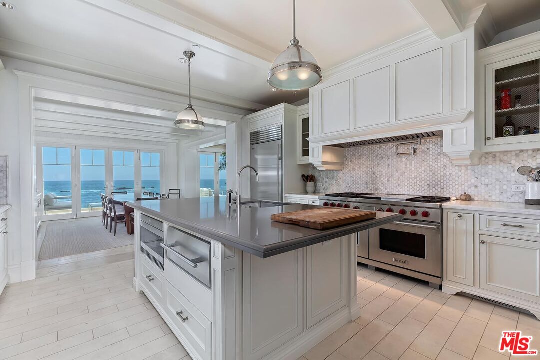 119 Malibu Colony Road Malibu, CA 90265 - Photo 8 of 24 a kitchen with stainless steel appliances granite countertop a stove and cabinets