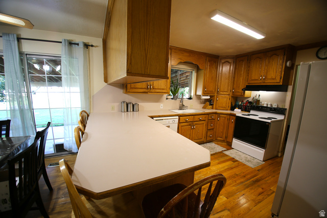 1612 East 450 South Springville, UT 84663 - Photo 17 of 48 Kitchen featuring wood-finish flooring, light wood cabinetry, a white countertop, and a white oven