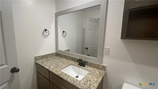 a bathroom with a sink and mirror