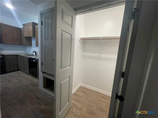 a view of kitchen with refrigerator and stove