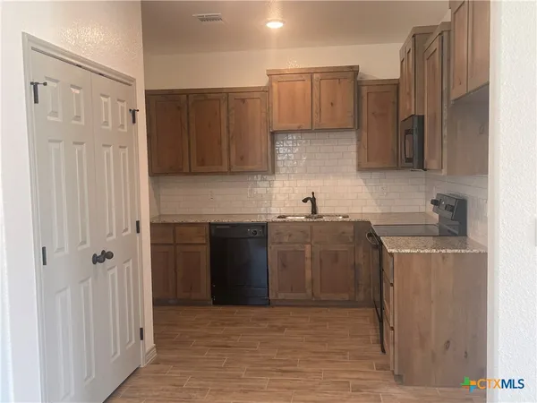 a kitchen with a sink and a refrigerator
