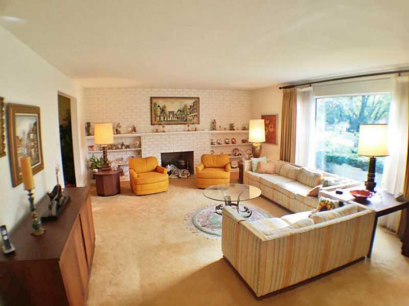 3216 Apache Road Bethel Park, PA 15241 - Photo 4 of 20 Living Room. Fireplace and brick accent wall anchor the large living room