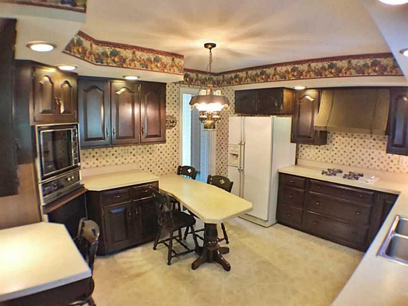 3216 Apache Road Bethel Park, PA 15241 - Photo 8 of 20 Kitchen. Dark cherry cabinets & neutral counter tops accent the kitchen