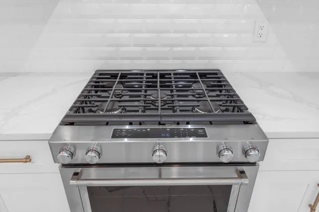 a view of an empty room with window and bathroom