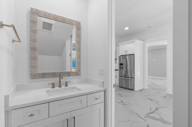 a bathroom with double sink and a mirror