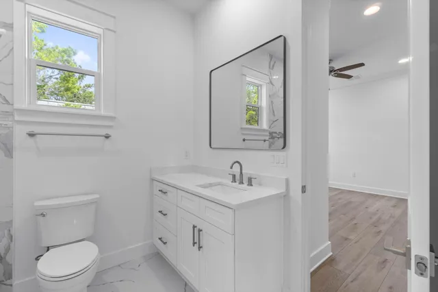 an aerial view of a house with a yard and large trees