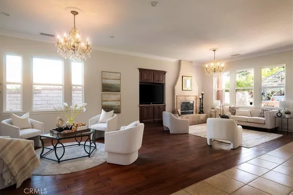 a living room with furniture and a chandelier
