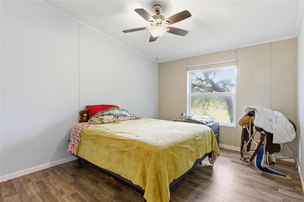 134 Private Road 4523 Decatur, TX 76234 - Photo 22 of 39 a bed sitting in a bedroom next to a window