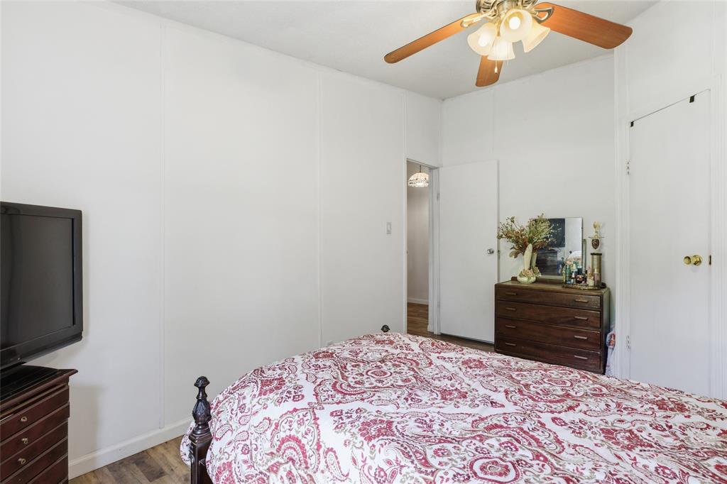 134 Private Road 4523 Decatur, TX 76234 - Photo 28 of 39 a bedroom with a bed and a flat tv screen on a dresser