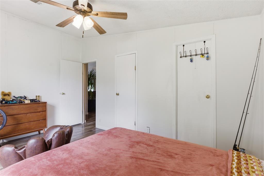 134 Private Road 4523 Decatur, TX 76234 - Photo 30 of 39 a bedroom with a bed and a chandelier fan