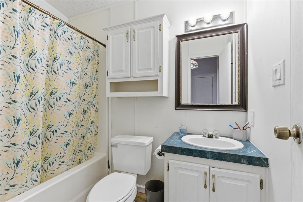 134 Private Road 4523 Decatur, TX 76234 - Photo 31 of 39 a bathroom with a granite countertop sink and a toilet