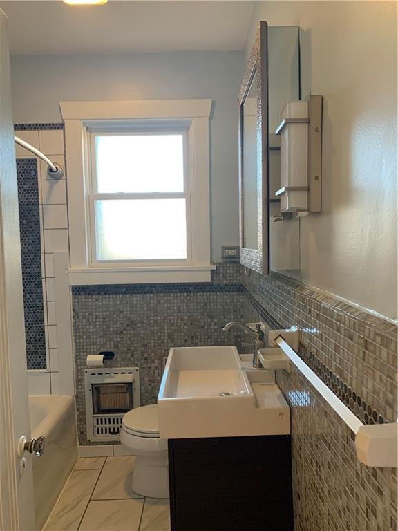 2607 Shady Avenue Pittsburgh, PA 15217 - Photo 12 of 19 a bathroom with a sink a toilet and mirror
