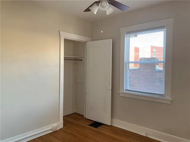 a view of an empty room with a fireplace and a window