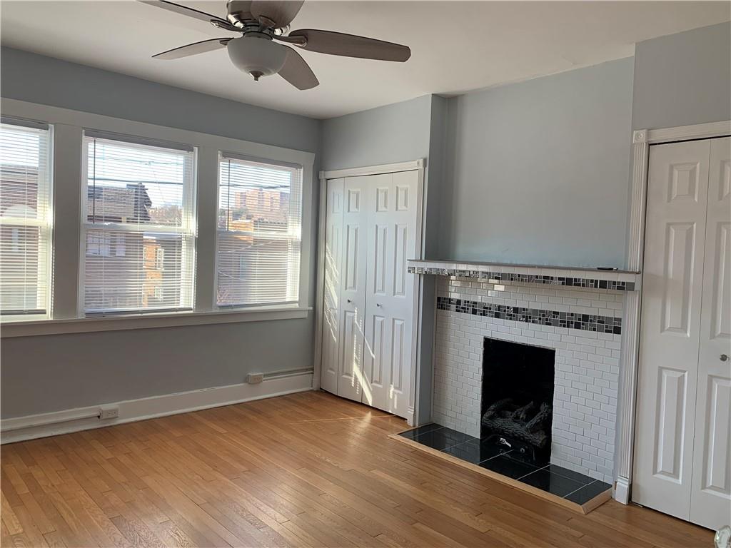 2607 Shady Avenue Pittsburgh, PA 15217 - Photo 14 of 19 a view of an empty room with a fireplace and a window
