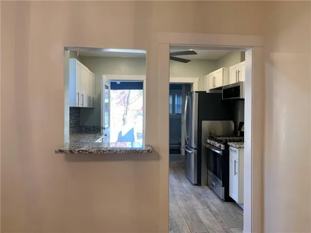 a kitchen with granite countertop a sink and cabinets
