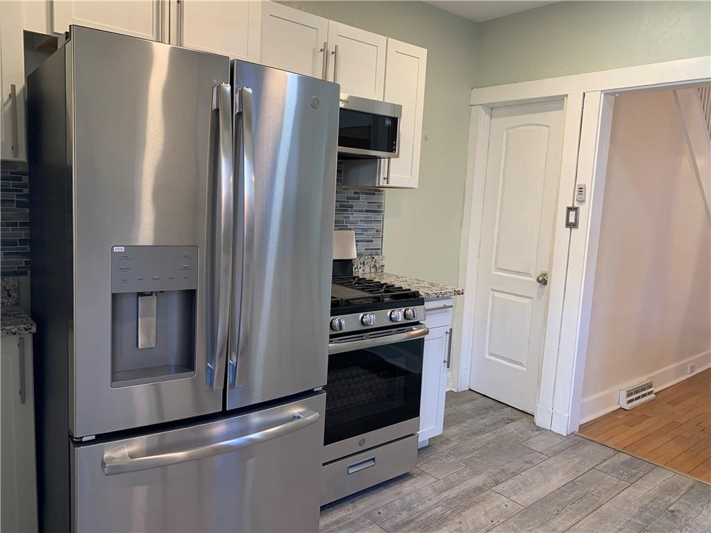 2607 Shady Avenue Pittsburgh, PA 15217 - Photo 8 of 19 a kitchen with stainless steel appliances a refrigerator stove and microwave