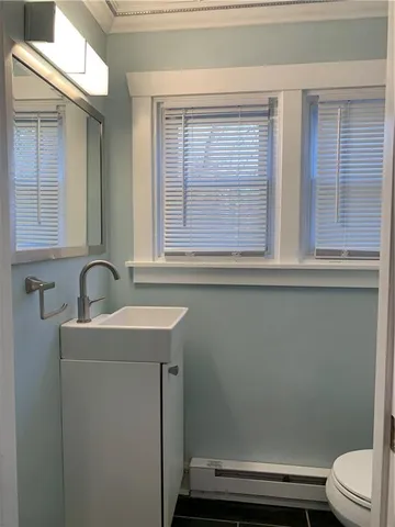 a view of empty room with window and chandelier fan
