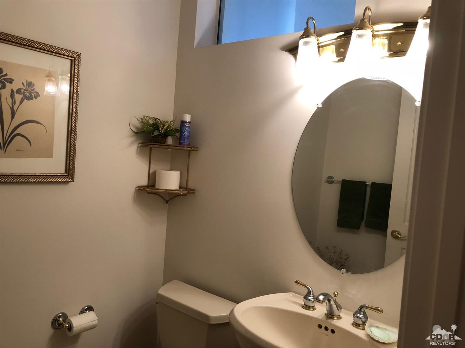 36626 Tallowood Drive Palm Desert, CA 92211 - Photo 11 of 17 a bathroom with a sink mirror and toilet