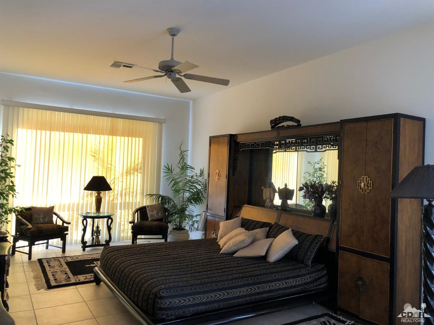 36626 Tallowood Drive Palm Desert, CA 92211 - Photo 12 of 17 a bedroom with a bed and wooden floor