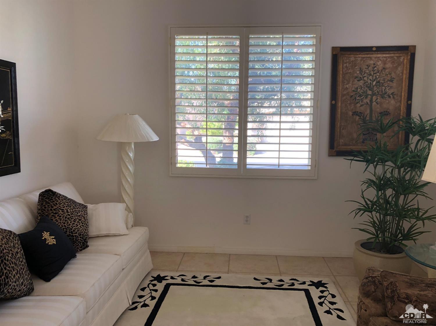 36626 Tallowood Drive Palm Desert, CA 92211 - Photo 14 of 17 a room with a couch and a potted plant