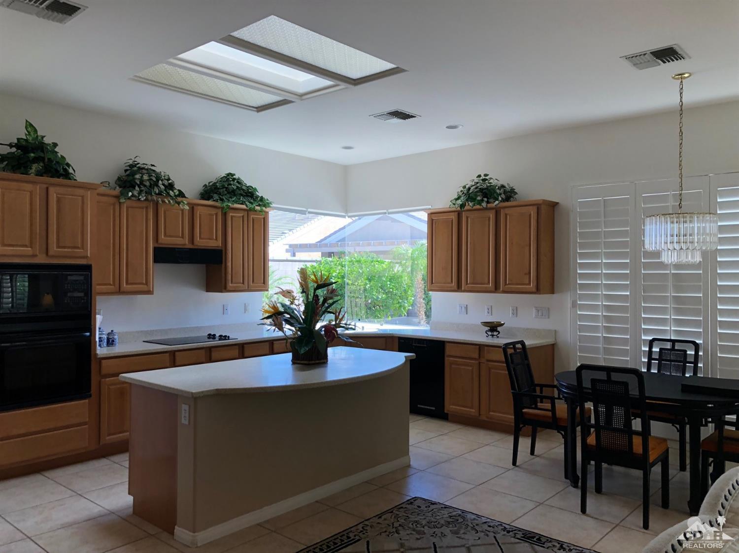 36626 Tallowood Drive Palm Desert, CA 92211 - Photo 5 of 17 a kitchen with a sink and cabinets