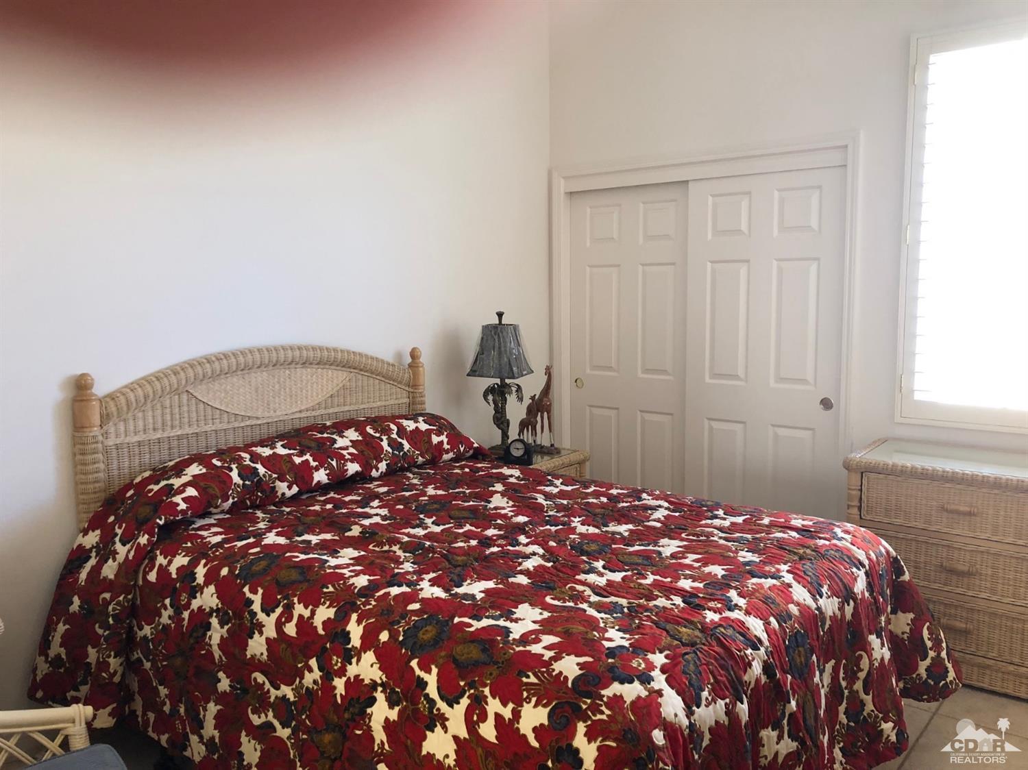 36626 Tallowood Drive Palm Desert, CA 92211 - Photo 7 of 17 a bedroom with a bed and window