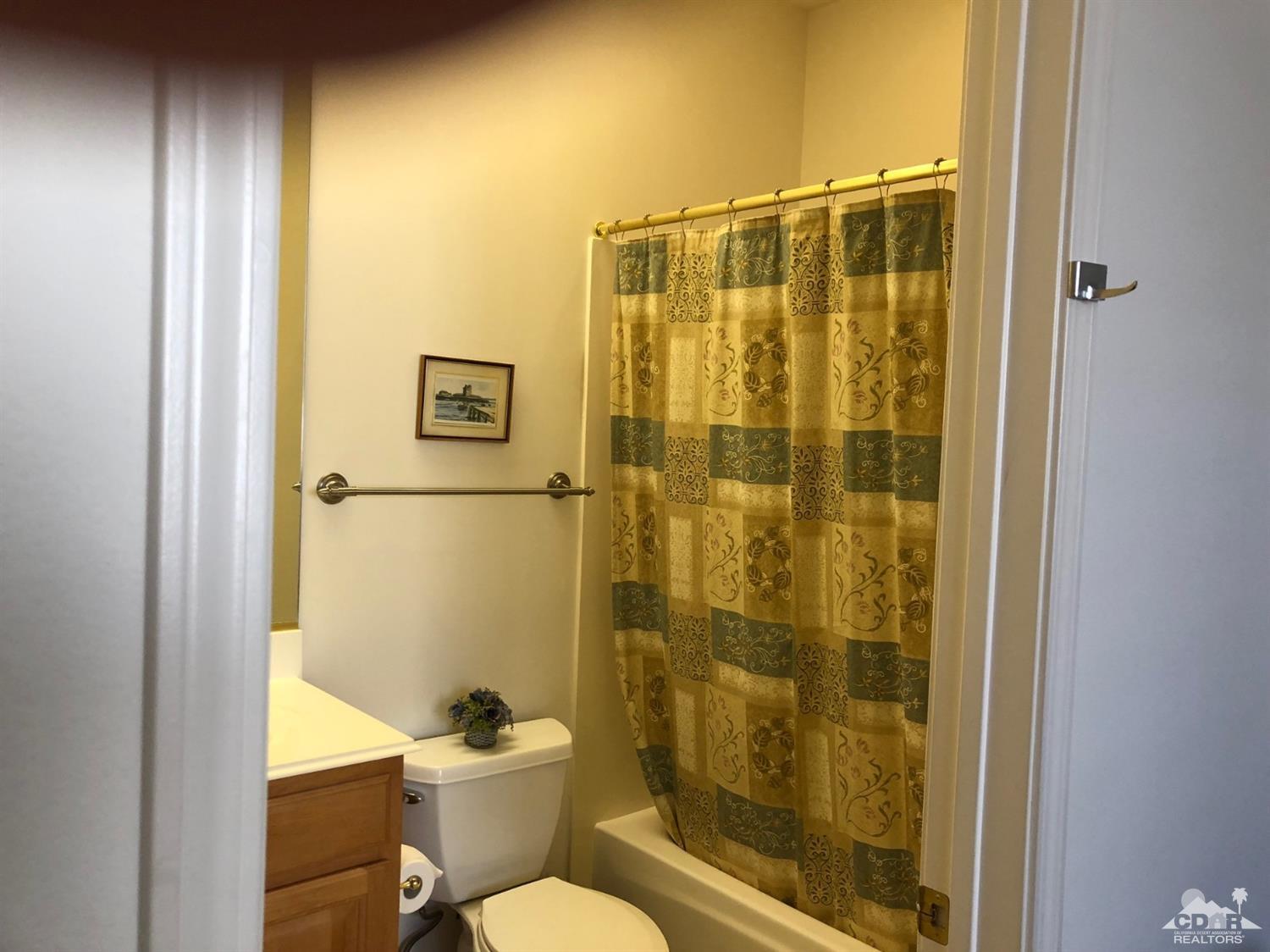 36626 Tallowood Drive Palm Desert, CA 92211 - Photo 8 of 17 a bathroom with a shower a toilet and a sink