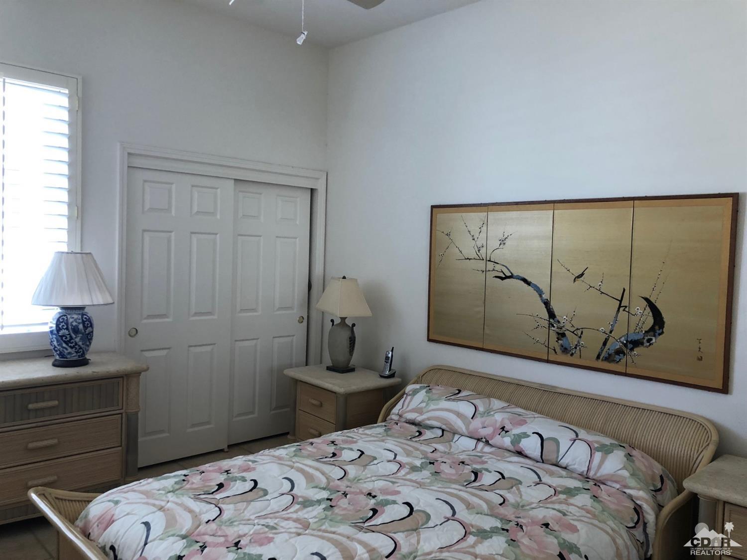 36626 Tallowood Drive Palm Desert, CA 92211 - Photo 9 of 17 a bedroom with a bed and a window