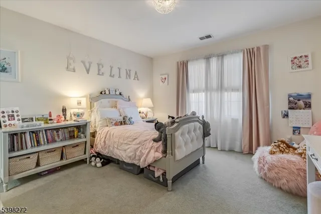 a spacious bedroom with a bed and a window