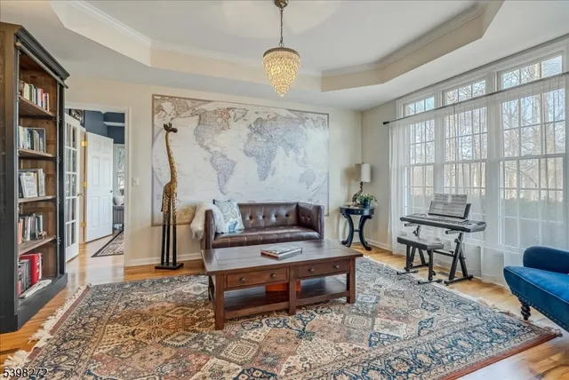 a living room with furniture a rug and a book shelf