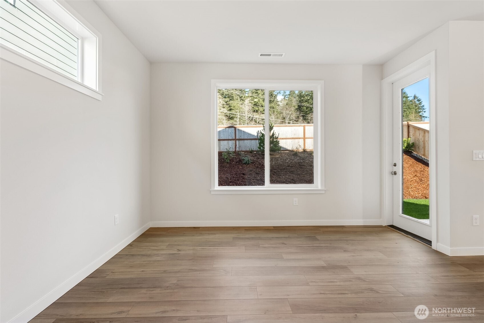 2064 Northeast Norseman Way Poulsbo, WA 98370 - Photo 11 of 28 a view of an empty room with wooden floor and a window