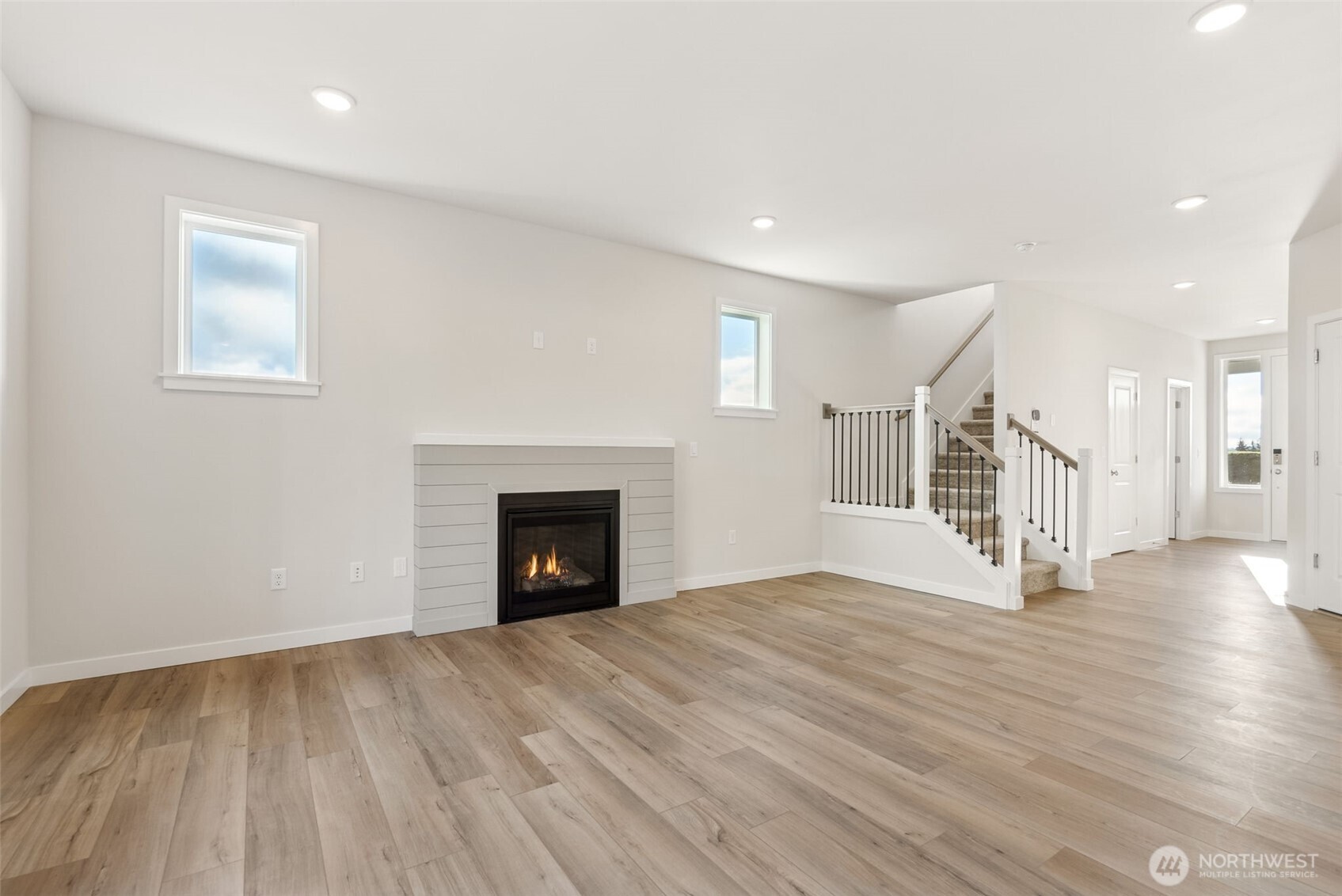 2064 Northeast Norseman Way Poulsbo, WA 98370 - Photo 13 of 28 a view of empty room with wooden floor and fireplace