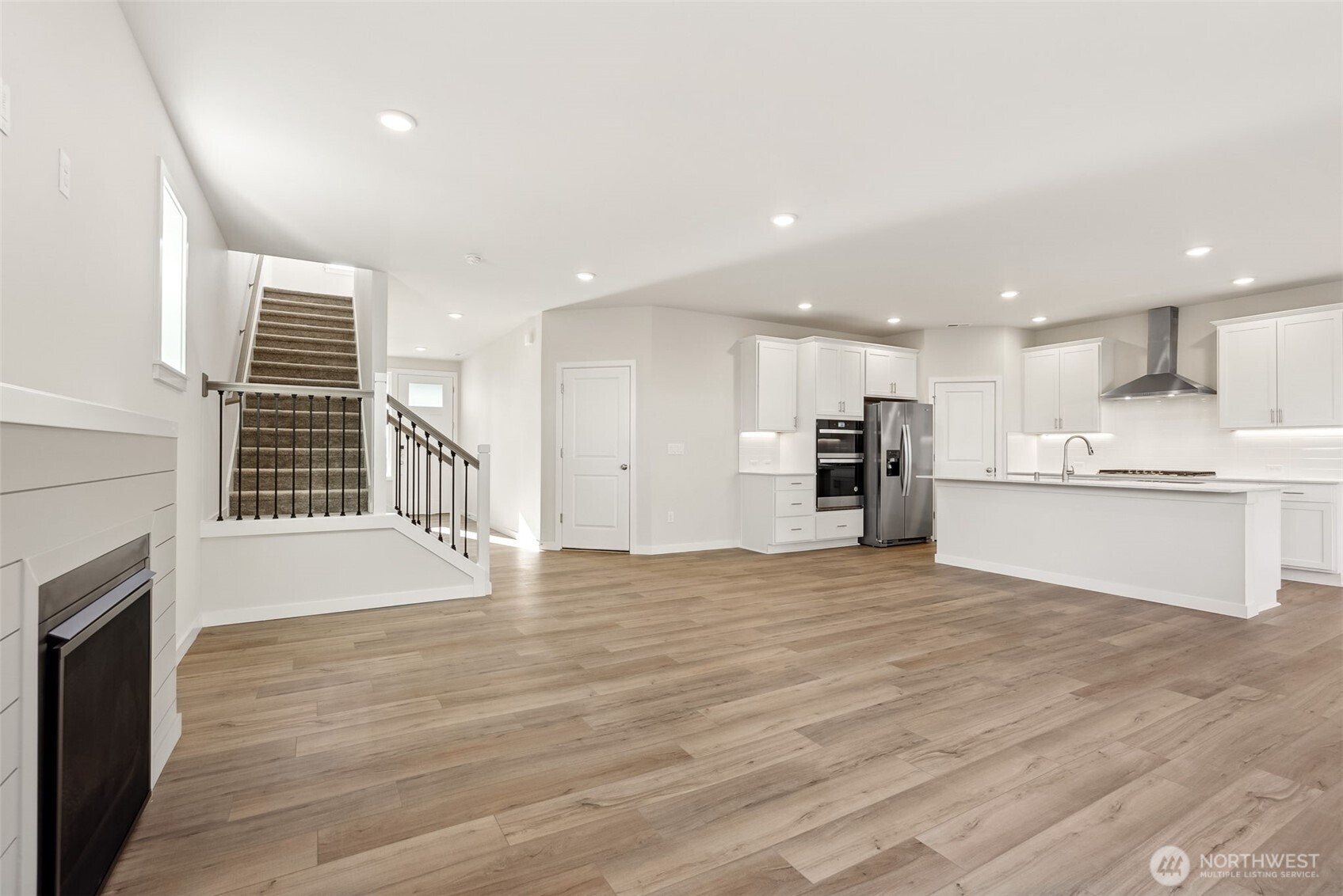 2064 Northeast Norseman Way Poulsbo, WA 98370 - Photo 14 of 28 a view of kitchen with kitchen island a sink wooden floor and a refrigerator
